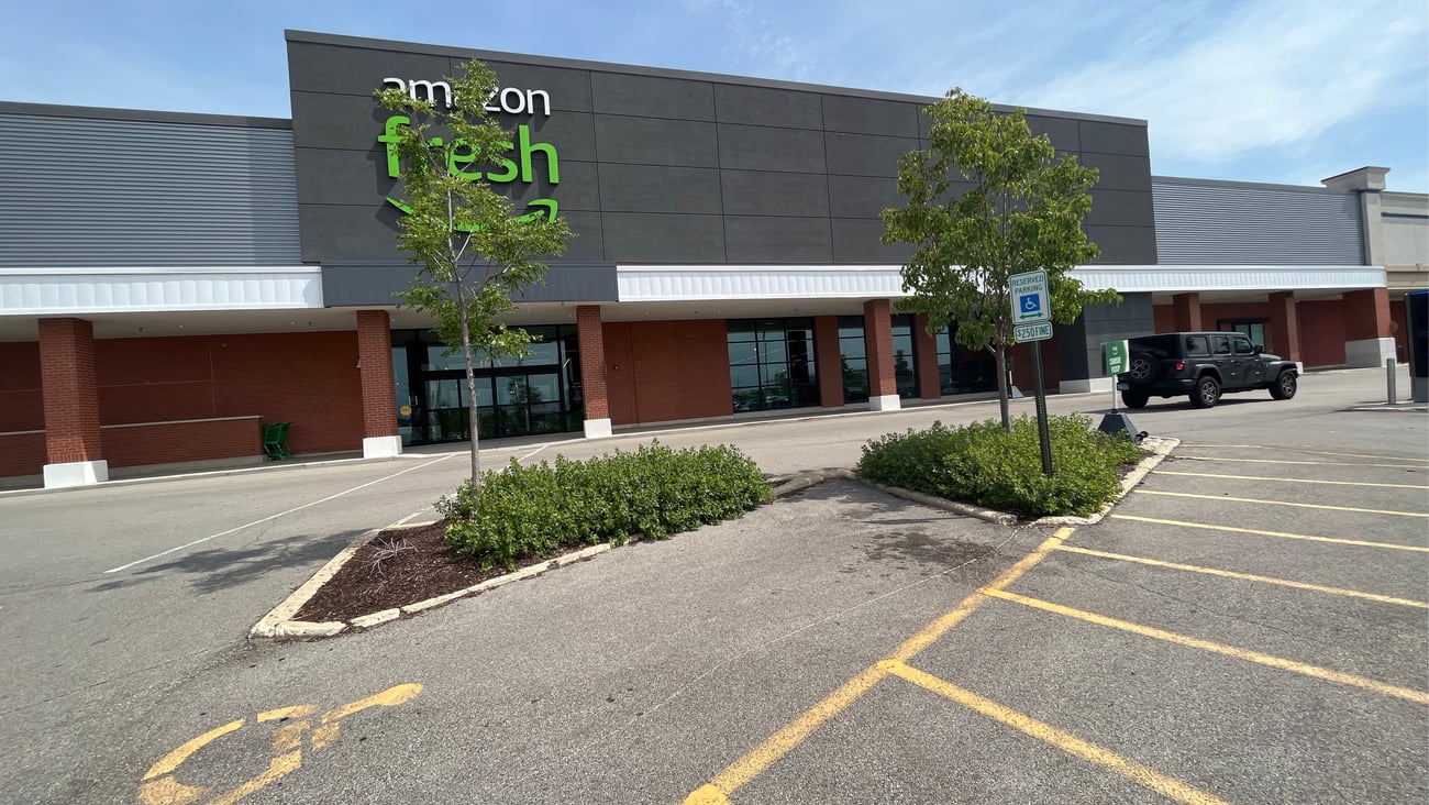 an empty parking lot in front of a house