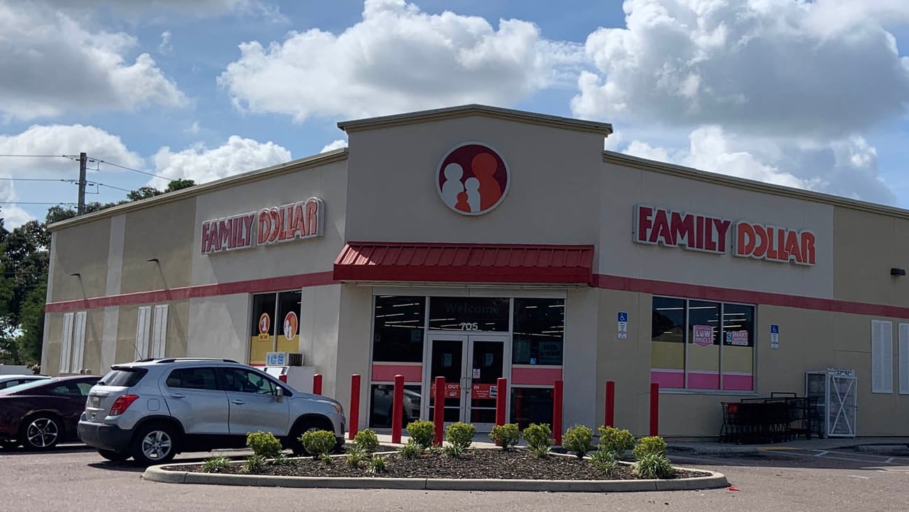 a car parked in a parking lot in front of a store