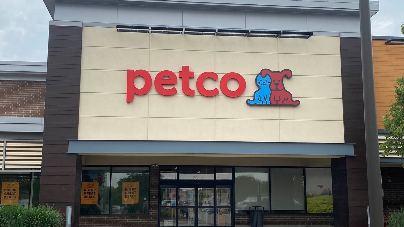 a sign above a store in a brick building