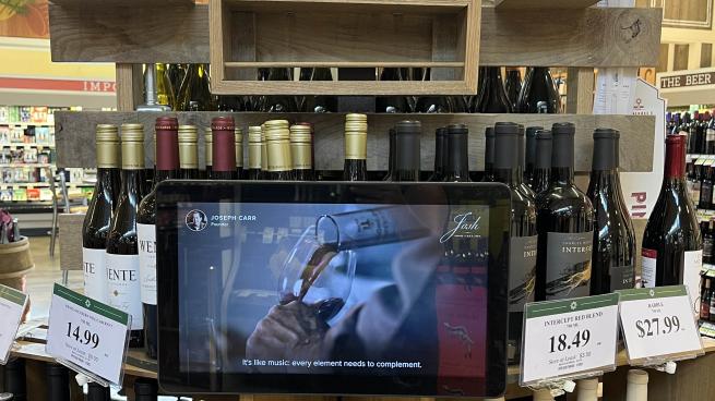 a bottle of wine in front of a store